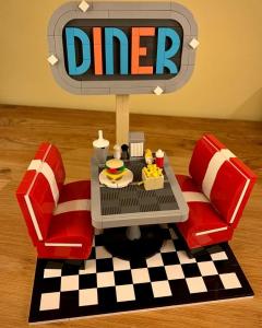 LEGO MOC - Retro Diner, designed by Zachary Steinman, realistic and artistic restaurant scene from the 50s in LEGO bricks